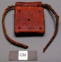 Amulet, leather square, stamped deco, looped at top w/ twisted cord, broken