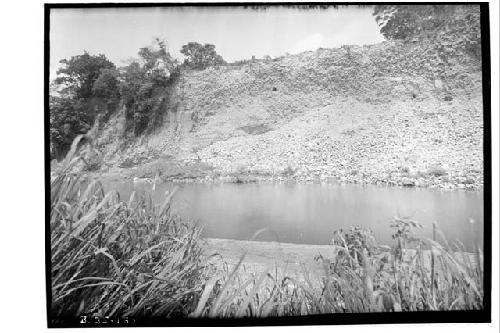 View from Copan River of high cut made by it into the ruins