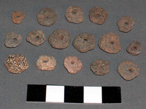 16 small perforated stone objects - beads?