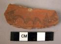 Rim potsherd - red painted and relief, unslipped (A1)