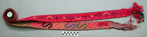 Red belt. black and white striped segment in center, one half magenta and one ha