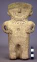 Large standing pottery figurine - hands clasped to chest