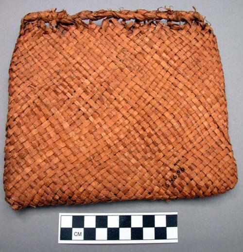 Cedar-bark bag, mush-kim-ul-tenss, hung from cross beam