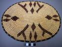 Flat basketry plaque, 12" long x 6" wide