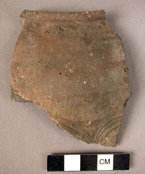 Potsherds - unburnished, faint circular incisions;