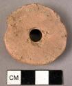 Red stone circular spindle whorl