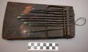 Piano-thin iron strips (9) of various lengths mounted on hollow rectangular wood