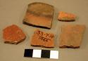 Red-on-black and red potsherds