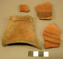 Red-on-black and red potsherds