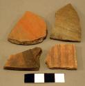 Red-on-black and red potsherds