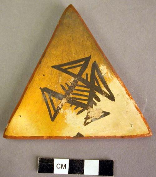 Triangular pottery tile; "Mana emblem"