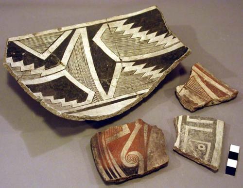 Ceramic sherds, black on white geometric and human designs, mended