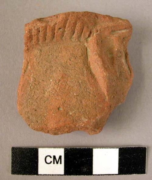 Rim potsherd - red-brown, relief and incised