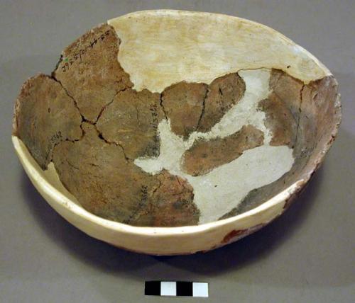 Undecorated partial pottery bowl, reconstructed