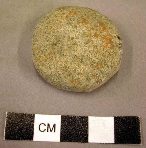 Plain pottery small disc from a reused potsherd