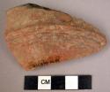 Potsherd - shiny red exterior, shiny black interior, grooved