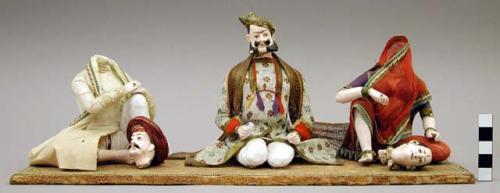 Figurine of 3 members of a singing party, 2 heads broken off but present