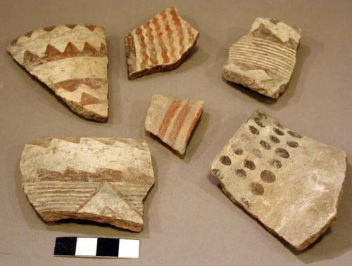 Ceramic rim and body sherds, red on white, various geometric designs