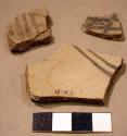 "intrusive" black on white potsherds