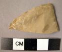Flint fragment of bevelled-base triangular point or convergent scraper, unifacka