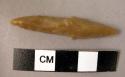 Flint elongated, narrow, double-ended point with slight shouldering at middle; t