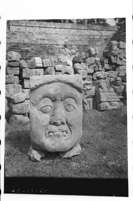 Sculptured face of old man with fangs