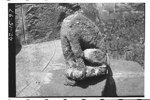 Headless stone figure of animal sitting on its haunches