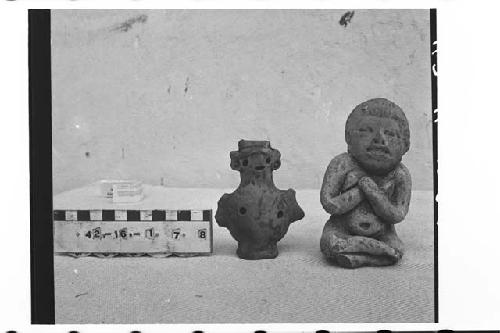 Two small, cream-colored ceramic figurines