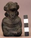 Black pottery figurine  - seated figure