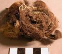 Organic fur fragments with clay adhered