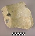 Stone, ground stone mortar fragment, square edge, concave top, with cortex