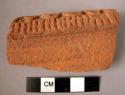 Rim potsherd - red-brown, relief and incised