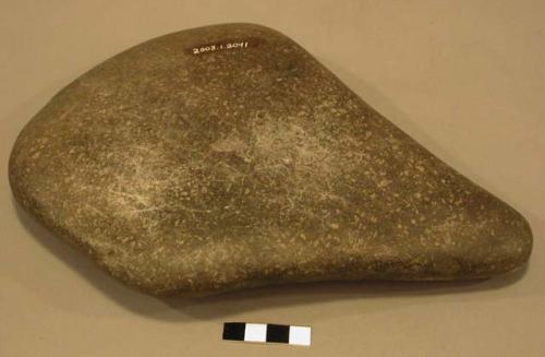 Stone, ground stone implement, triangular, pitted surface, 1 edge sharpened