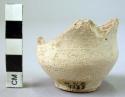 Pottery cup fragment, base and part of sides present - plain ware, light, slippe