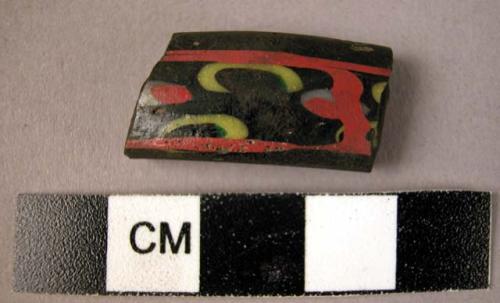 Glass bangle fragment - black background, red & yellow design