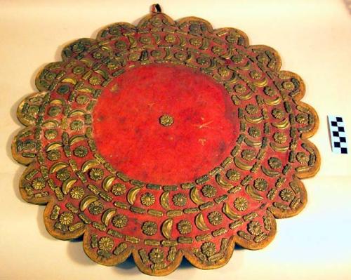 Shield, leather with applied metal elements, scalloped fabric edges