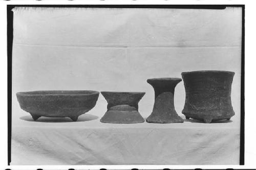 From left to right: clay tripod bowl with recurved sides - two clay pot stands -