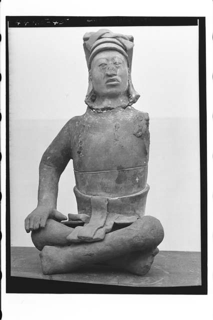 Large pottery figure seated crossed leg