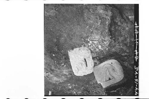 Flat profile stone heads, in situ along E edge of Burial D fragments after remov