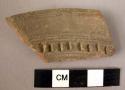 Rim potsherd - dark brown, incised decoration