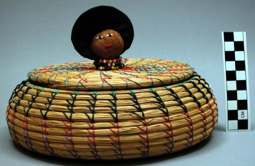 Coiled bowl-shaped basket (A), with lid (B), representing Seminole woman