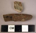 2 potsherds - dark brownish; 1 incised