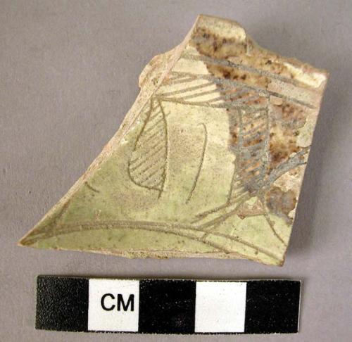 Rim potsherd - cream and brown glaze