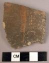 Potsherd - red trickle painted on dark grey brown ware