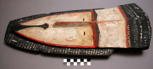 Wooden mask; white pigment with black and red outlines, cross-hatched and chevro