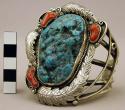 Cuff bracelet, lg. turq. stone surrounded by coral stones and floral motifs