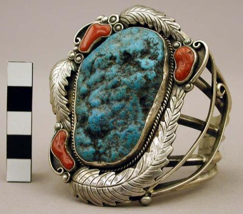 Cuff bracelet, lg. turq. stone surrounded by coral stones and floral motifs