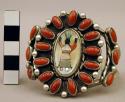 Cuff bracelet, inlaid katsina figure surrounded by oval coral stones