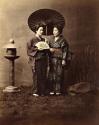 Two young Japanese women in traditional dress, one holding a parasol