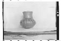 Plumbate standard jar, gadrooned. Max. ht. 8.8cm., max. diam. 8.5cm. Color: tan